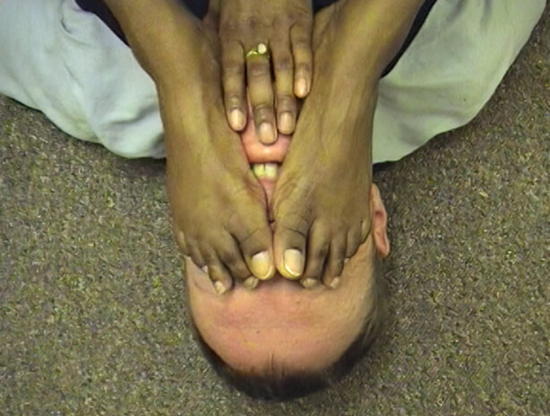 Black hands and feet over him