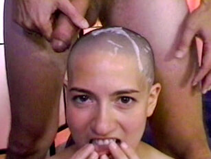 Cumming over a shaved headed female head and feeding it to her