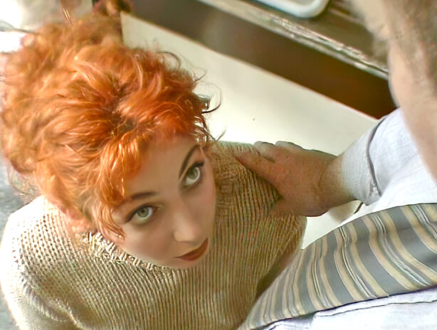 Redhead on her knees sucks off an old mans small erect penis 