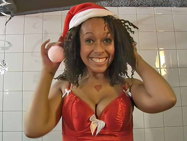 Ebony in a Santa outfit takes a bottom spanking