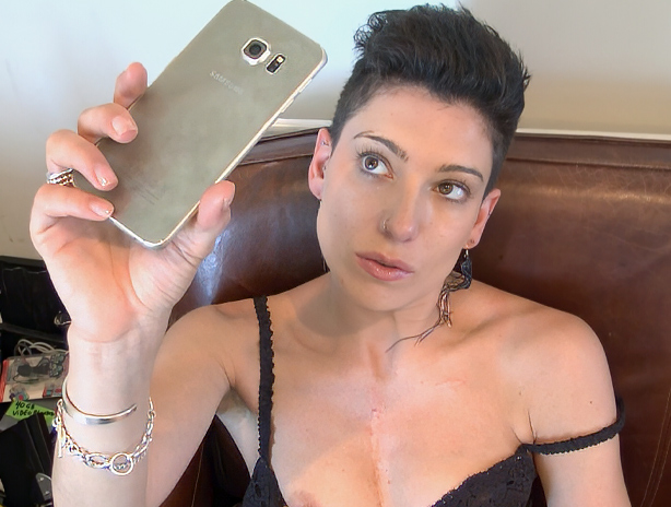 Charlie Love in skimpy black bra and panties rubs her pussy while taking selfies