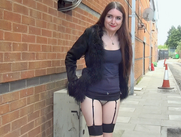 Daring brunette flashing her bald pussy and tits in public